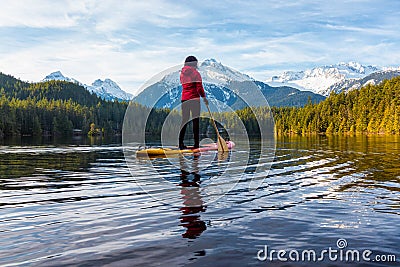 Adventurous Girl Paddle Boarding on Levette Lak Stock Photo