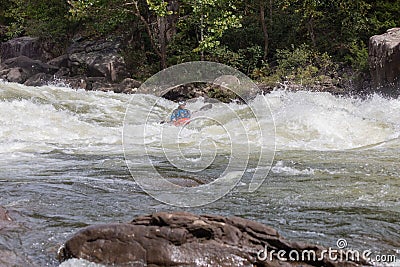 Adventurous kayaker paddling through the rough rapids on the Gauley River in West Virginia Editorial Stock Photo