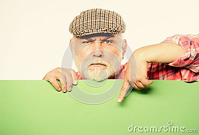 Advertisement shop. Pensioner grandfather in vintage hat hold poster information copy space. Event announcement Stock Photo