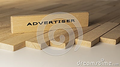 Advertiser written on wooden surface. Concept created from wooden sticks Stock Photo