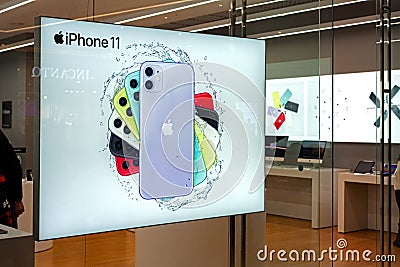 MINSK, BELARUS - March 3, 2020: Advertising banner of the new iPhone in the storefront of Apple Store Editorial Stock Photo