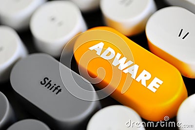 Adware - unwanted software designed to throw advertisements up on your screen, text concept button on keyboard Stock Photo