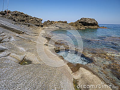 Aegean sea cliffs and a beautiful small basin like a private Jacuzzi. Stock Photo