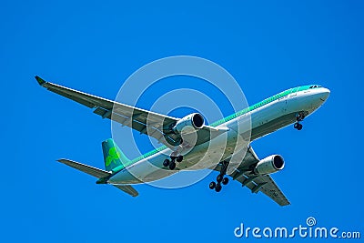 Aer Lingus plane descending for landing at JFK International Airport in New York Editorial Stock Photo