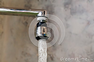 Aerator nozzle on faucet mixer with rotating head. A close-up photograph of a frozen moment flowing from a tap water Stock Photo