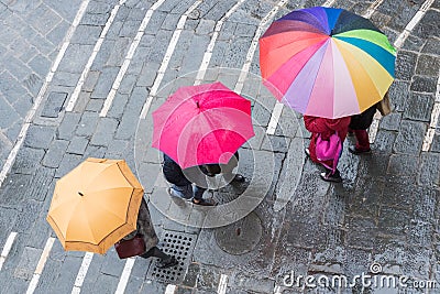 Aereal view of people holding colorful umbrellas Stock Photo