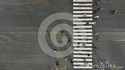 Aerial. Asphalt road with zebra pedestrian crosswalk and crowd of people. Top view Stock Photo