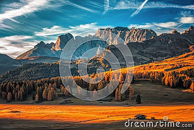 Aerial autumn sunrise scenery with yellow larches and small alpine building and Odle - Geisler mountain group on background. Stock Photo