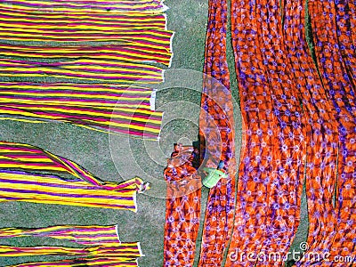 Aerial Batik worker drying batik cloth Stock Photo