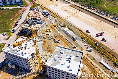 Aerial Bird Eye View Of a Construction Site Building Cranes Looking Down Industrial Machinery Area around Residential Urban Stock Photo