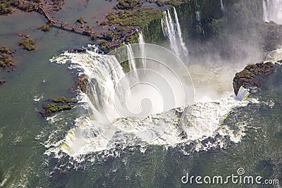 Aerial bird`s-eye view of beautiful rainbow above Iguazu Falls Devil`s Throat chasm from a helicopter flight. South America. Stock Photo