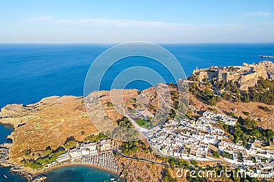 Aerial birds eye view drone photo of village Lindos, Rhodes island, Dodecanese, Greece. Sunset panorama with castle, Mediterranean Stock Photo