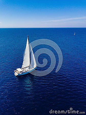 Aerial view from drone of white yacht in deep blue sea Stock Photo