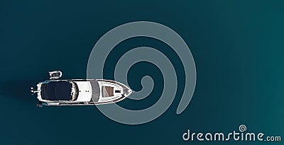 Aerial yacht on calm sea. Luxury cruise trip. View from above of white boat on deep blue water. Aerial view of rich Stock Photo