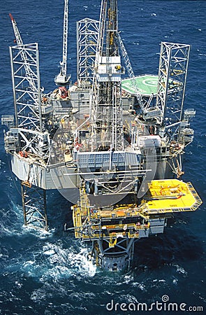 Aerial of Bream B platform with huge Maersk jackup rig towering over it. Stock Photo