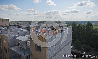 Aerial Building Process of Construction Site. Engineers crane and city Editorial Stock Photo
