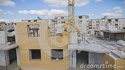 Aerial Building Process of Construction Site. Engineers crane and city Editorial Stock Photo