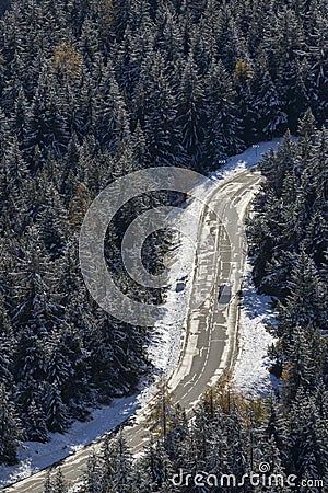 Aerial of a car on road in a forest with snow Stock Photo