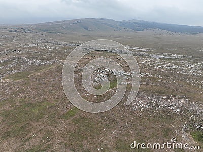 Aerial Cinematic slow motion shot of Drone Flying over a large herd of wild horses galloping fast across the steppe. Stock Photo
