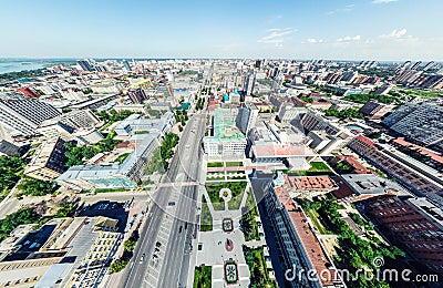 Aerial city view with crossroads and roads, houses, buildings, parks and parking lots. Sunny summer panoramic image Editorial Stock Photo