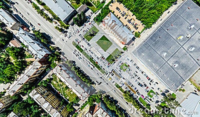 Aerial city view with crossroads and roads, houses, buildings, parks and parking lots. Sunny summer panoramic image Editorial Stock Photo