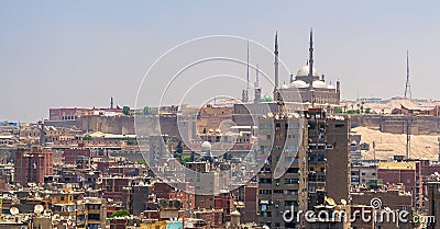 Aerial cityscape view of old Cairo, Egypt with old buildings and Citadel of Egypt in far distance Stock Photo