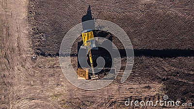 Aerial construction - top down view of an excavator and truck working on a construction site Stock Photo