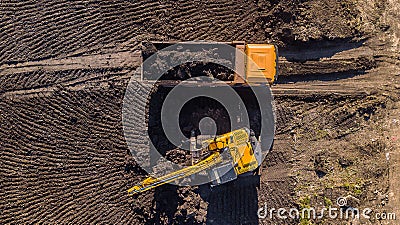 Aerial construction - top down view of an excavator and truck working on a construction site Stock Photo