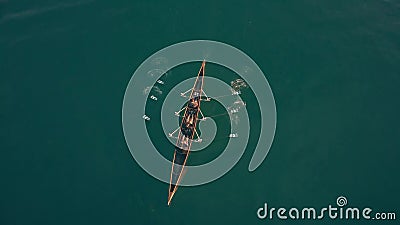 Aerial down view of three unknown people rowing in a boat Stock Photo