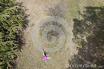 Aerial drone view of young woman with straw hat Stock Photo