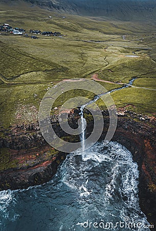 Aerial drone panorama of Mulafossur waterfall, Vagar, Faroe Islands, Denmark. Rough see in the north atlantic ocean Stock Photo