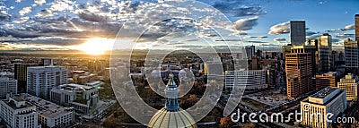 Aerial Drone Panorama - Stunning golden sunset over the Colorado state capital building & Rocky Mountains, Denver Colorado. Stock Photo