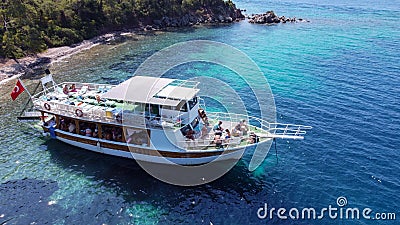 Aerial drone photo of pleasure yacht anchored in crystal clear bay and turquoise beach. uninhabited island in Editorial Stock Photo