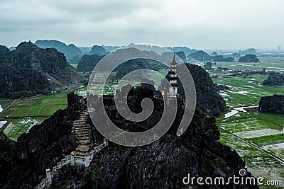 Aerial drone photo - Woman next to a shrine atop a mountain in northern Vietnam. Hang Mua Stock Photo