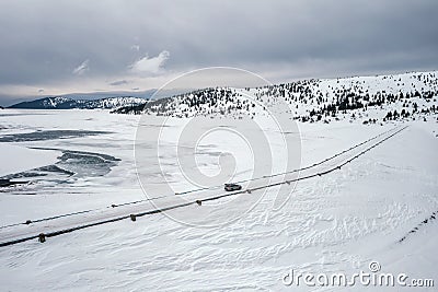 Aerial landscape with a car on the winter road Stock Photo