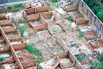 Aerial drone shot of broken demolished brickwork houses with fallen walls due to razing of illegal construction or natural Stock Photo