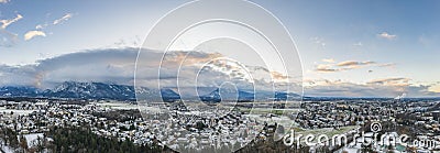 Aerial drone shot view of outskirts and austrian alps untersberg with heavy fog in winter Stock Photo