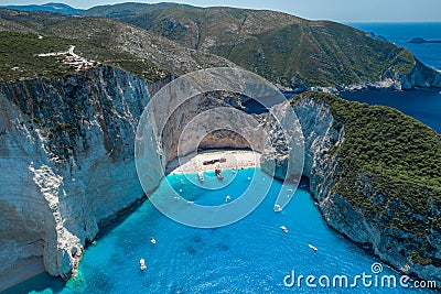 Aerial drone shot of Zakynthos Navagio beach with tourists with cruise ship in blue Ionnian sea Stock Photo