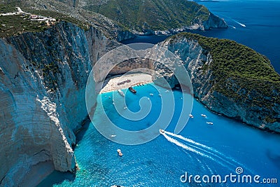 Aerial drone shot of Zakynthos Navagio beach with tourists with cruise ship in blue Ionnian sea Stock Photo