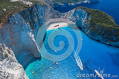 Aerial drone shot of Zakynthos Navagio beach with tourists with cruise ship in blue Ionnian sea Stock Photo