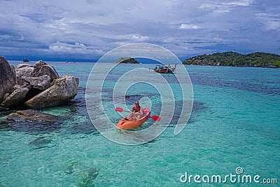 Aerial top view of man kayaking in crystal clear lagoon sea water near Koh Kra island in Thailand Stock Photo