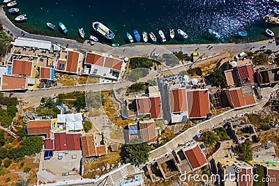 Aerial drone top view photo of colourful wooden traditional fishing boat in turquoise sea shore of Simy island, Greece Stock Photo