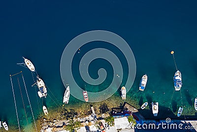 Aerial drone top view photo of colourful wooden traditional fishing boat in turquoise sea shore of Simy island, Greece Stock Photo