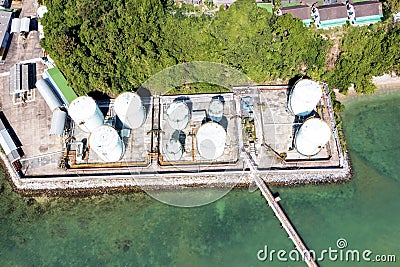 Aerial drone top view of tank farm oil and gas terminal with lots of fuel petroleum chemical natural gas storage tank and Stock Photo