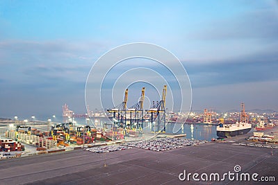 Aerial drone view above dockyard. Scenic view of cargo industrial commercial port in dawn. Stock Photo