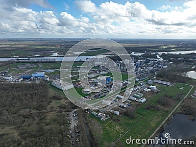 Aerial drone view agricultural industrial installation along the Ghent Terneuzen canal. Processing, distribution and Stock Photo