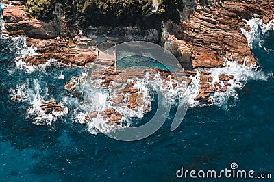 Aerial drone view of Blue Pool in Bermagui during sunrise sunset with blue sky and reflection. New South Wales Stock Photo