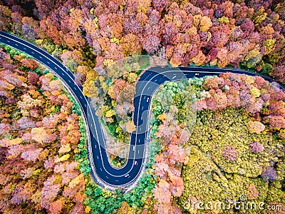 Aerial drone view of a curved winding road through the forest hi Stock Photo