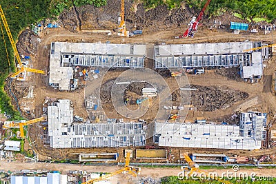 Aerial drone view of excavator loading the tipper truck at the construction site Stock Photo