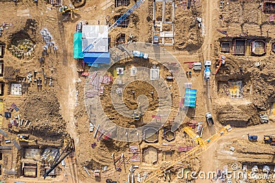 Aerial drone view of excavator loading the tipper truck at the construction site Stock Photo